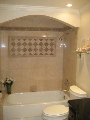 Inset bathtub with a square checker tile pattern behind it, all on a tan tile layout.